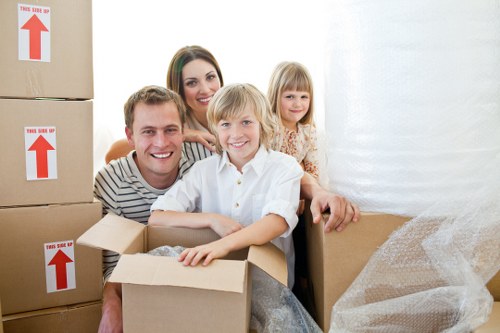 Professional movers carrying household furniture from a flat in Harringay