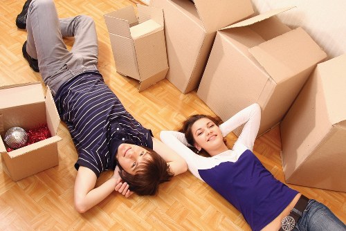 Packed moving boxes and furniture ready for transport in Harringay