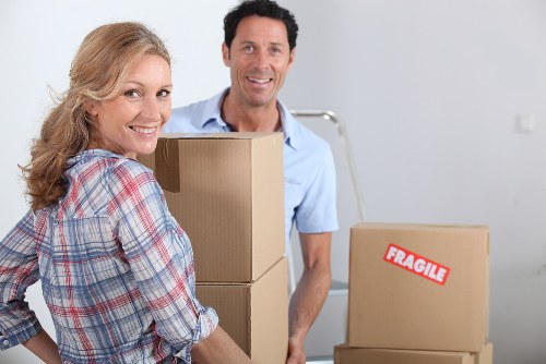 Movers handling furniture during a local house move in Harringay