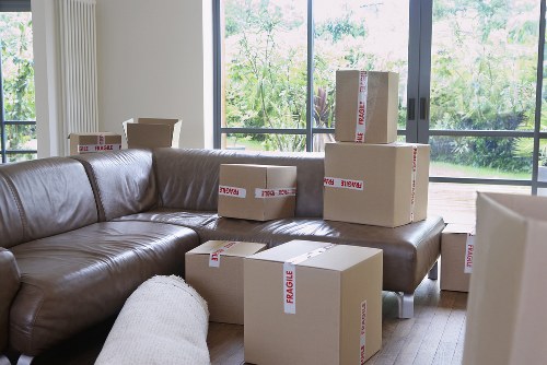 Local movers navigating stairs in a North London property